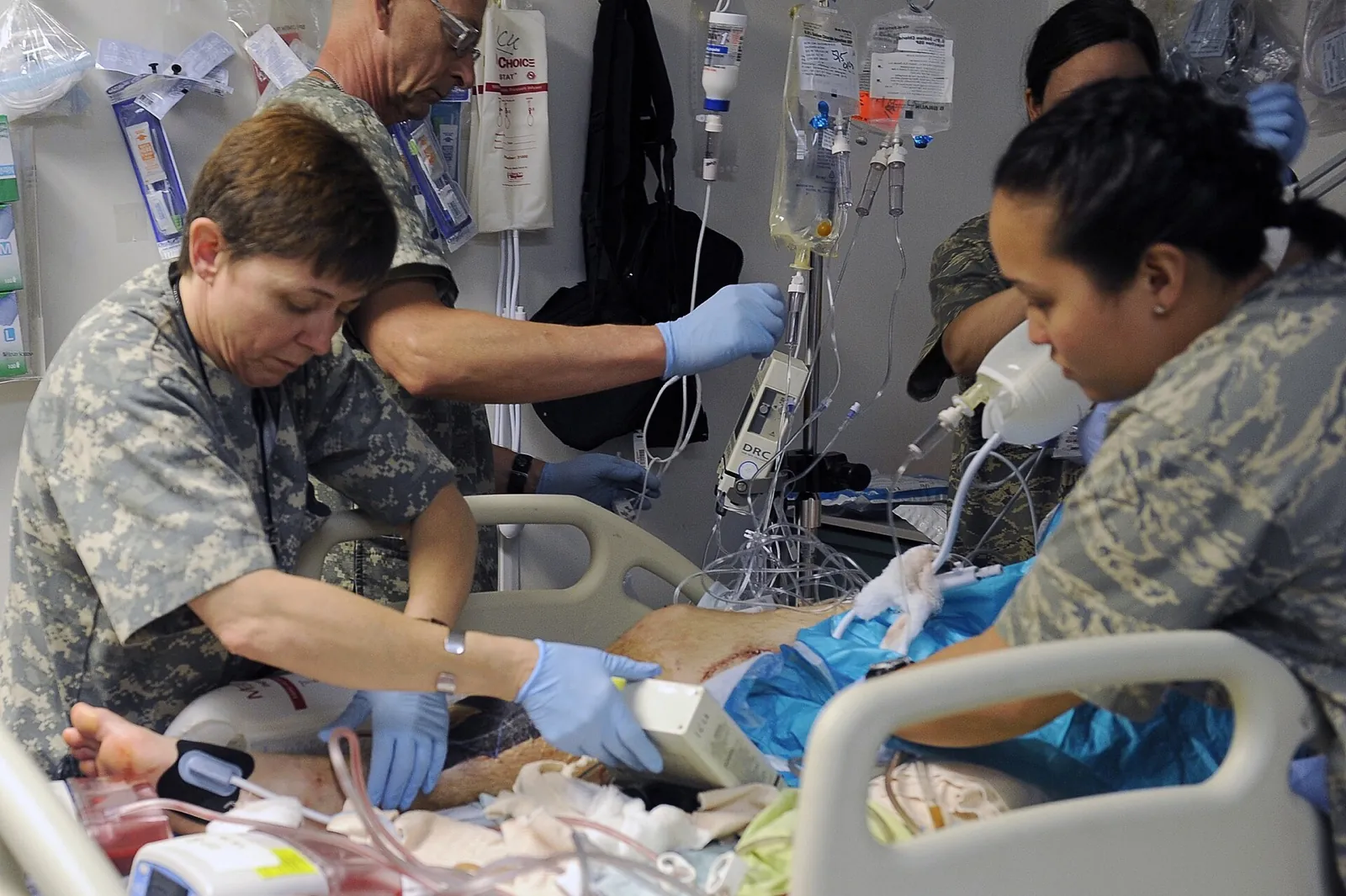 Medical technicians setting up hospital equipment in a ward